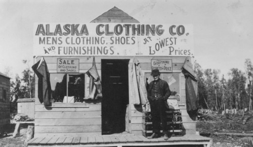 Man in front of Alaska Clothing Co. store, between c1900 and 1916. Creator: Unknown.