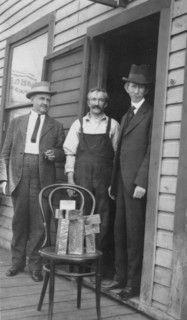 Delegate Wickersham, the assayer and Frank G. Carpenter in front of..., between c1900 and 1916. Creator: Unknown.