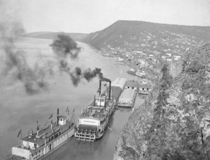 Riverboats distant view of town, between c1900 and 1923. Creator: Unknown.