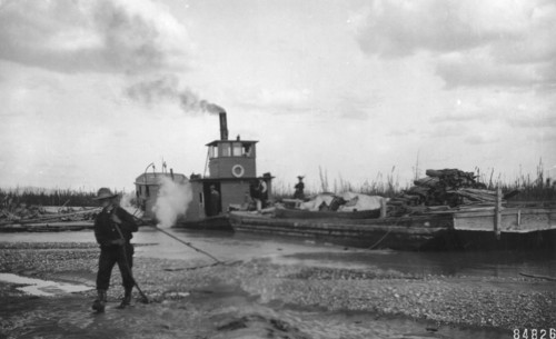 Steamer Little Delta and barge on sand bar, between c1900 and c1930. Creator: Unknown.