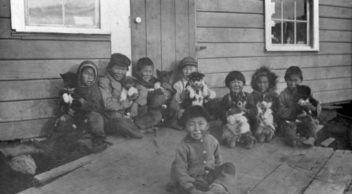 Eskimo children and puppies at the Moravian Mission Station, between c1900 and c1930. Creator: Unknown.