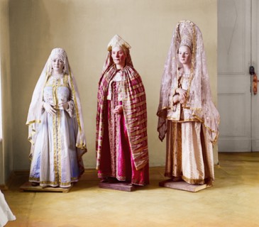 Three mannequins of women in elaborate dress, on wooden stands, between 1905 and 1915. Creator: Sergey Mikhaylovich Prokudin-Gorsky.