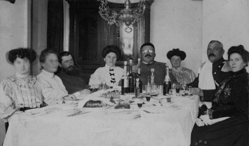 Fire Chief A. F. Domishkevich Sitting at a Table Set for a Holiday Together with..., early 20th cent Creator: Unknown.