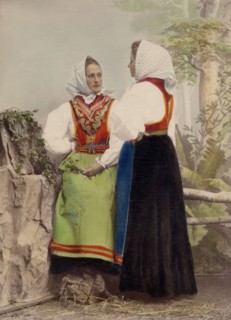 Two young women pose in folk costumes, with dotted headdresses, 1886-1890. Creator: Helene Edlund.