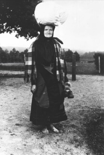 Barefoot woman carrying a sack on her head, walking to sell tissues, Mark's district,..., 1900-1910. Creator: Unknown.