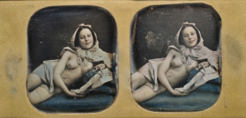 Young scantily clad woman, lying on her side.  Creator: Unknown.