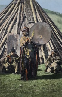 Altai Shaman with Tambourine in Front of a Traditional Dwelling (Chaadyr), 1911-1913. Creator: Sergei Ivanovich Borisov.