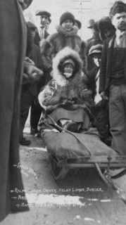 Ralph and Helen Lomen on dog sled, ready for race, 1915. Creator: Lomen Brothers.