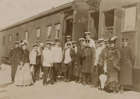 Railway employees against the background of train cars, 1910-1919. Creator: Unknown.