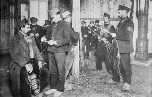Prisoners at Zossen making straw shoes, 24 Feb 1915. Creator: Bain News Service.