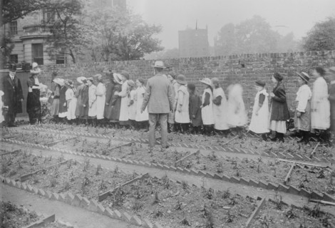 Lady Henry and T.P. O'Connor distribute cabbages, 1913. Creator: Bain News Service.