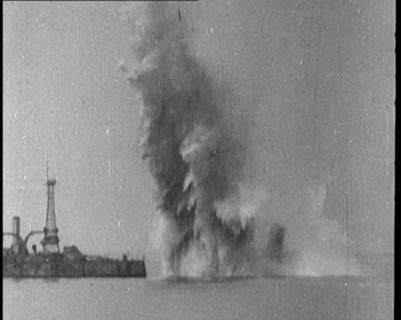 Bombs Dropped from Planes Exploding near a Warship, 1922. Creator: British Pathe Ltd.