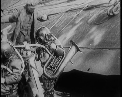 A Diver Coming up from the Sea Carrying a Tuba, 1929. Creator: British Pathe Ltd.