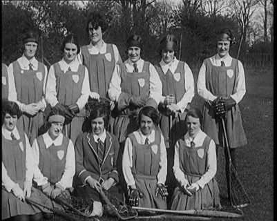 A Group of Young Female Civilians Wearing Gymslips Holding Lacrosse Sticks, 1920. Creator: British Pathe Ltd.