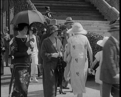 Civilians Walking Outdoors Wearing Evening Outfits and Hats, 1920. Creator: British Pathe Ltd.