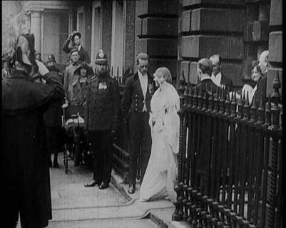 The Duke of York and Lady Elizabeth Bowes-Lyon Emerging from a House on Their Wedding Day, 1920. Creator: British Pathe Ltd.