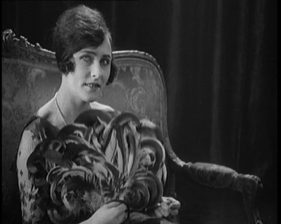 Female Civilian Using a Fan Made of Feathers, 1920. Creator: British Pathe Ltd.