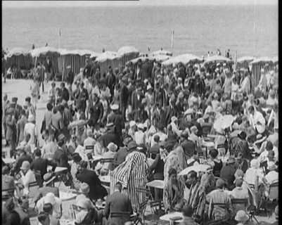 Civilians Enjoying a Sunny day on a Very Crowded Beach, 1920. Creator: British Pathe Ltd.