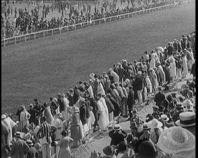 A Large Crowd of Civilians Watching a Horse Race, 1920. Creator: British Pathe Ltd.
