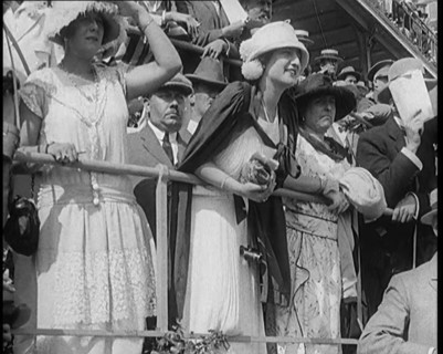 A Large Crowd of Civilians Wearing Smart Outfits and Hats Watching a Horse Race, 1920. Creator: British Pathe Ltd.