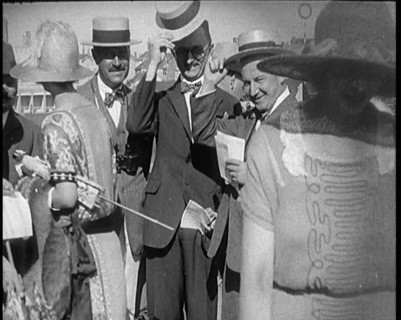 Civilians Wearing Smart Outfits and Hats Posing for the Camera During a Horse Race, 1920. Creator: British Pathe Ltd.