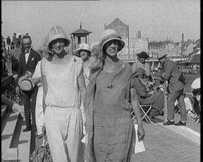 Two Female Civilians Wearing Smart Outfits Walking Towards the Camera in a Horse Race Event, 1920. Creator: British Pathe Ltd.
