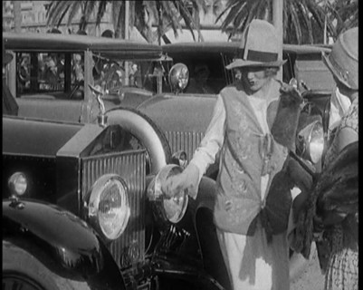 Two Female Civilians Wearing Glamorous Outfits Admiring a Luxurious Car, 1920. Creator: British Pathe Ltd.