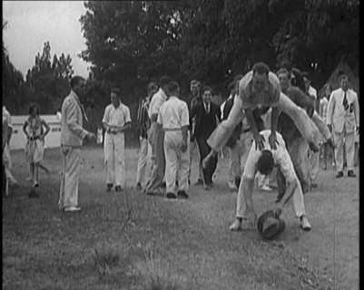 A Male Civilian Leapfrogging over Another Male Civilian Outdoors in a Holiday Camp, 1920. Creator: British Pathe Ltd.