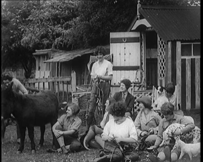 A Group of Young Female Civilians Sitting Outdoors with Various Animals Around Them, 1920. Creator: British Pathe Ltd.