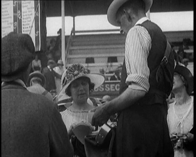 A Female Civilian Placing a Bet with a Bookie in a Horse Racing Event, 1920. Creator: British Pathe Ltd.