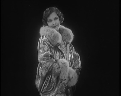 Female Civilian Modelling a Glamorous Fur Trimmed Coat, 1920. Creator: British Pathe Ltd.