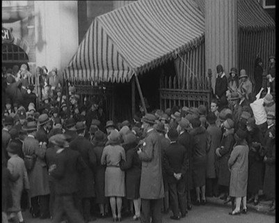 A Crowd of Civilians Gathering Under a Canopy Wearing Smart Outfits and Hats, 1920. Creator: British Pathe Ltd.