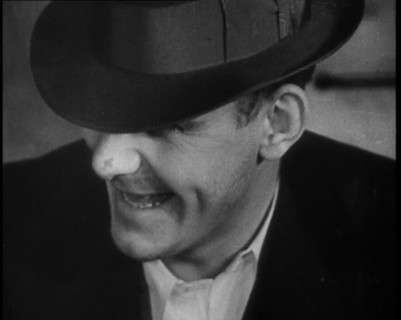Male American Civilian Wearing a Hat Sitting at a Desk, 1930. Creator: British Pathe Ltd.