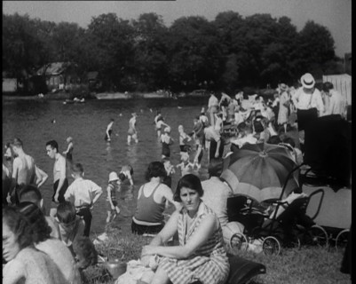 Large Group of People Sitting Outside and Paddling, 1933. Creator: British Pathe Ltd.