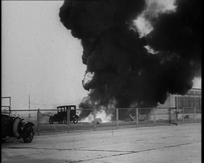 Plume of Flame Burning with Cars Nearby, 1933. Creator: British Pathe Ltd.