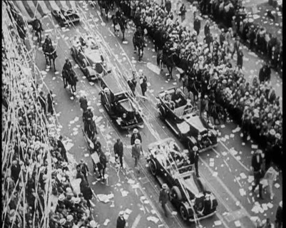 Cars Driving Down in a Parade Watched by Crowds, 1933. Creator: British Pathe Ltd.