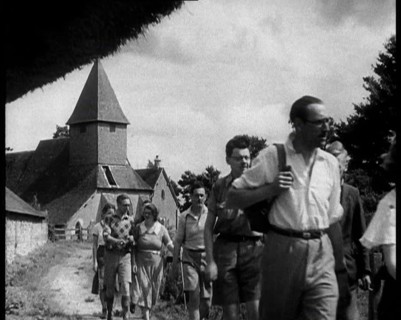 People Hiking with a Church in the Background, 1933. Creator: British Pathe Ltd.