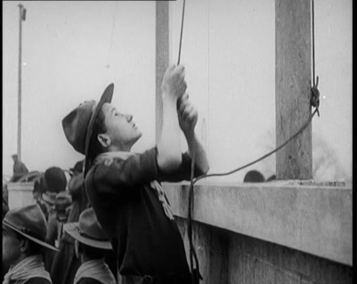 Male Boy Scout Unfurls the Flags of the British Empire, 1924. Creator: British Pathe Ltd.