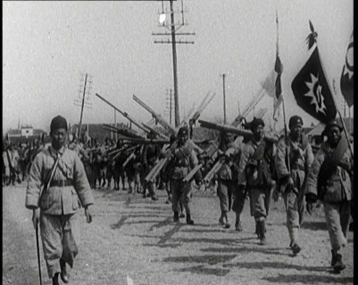 Chinese Soldiers Marching Carrying Flags and Other Equipment, 1920s. Creator: British Pathe Ltd.