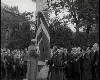 British Officer Pulling Down Union Flag to Reveal a Memorial Obelisk, 1920. Creator: British Pathe Ltd.