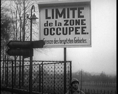 A Sign Read 'Limite de la Zone Occupee. Grenze des Besetzten Gebietes', a French Soldier..., 1924. Creator: British Pathe Ltd.