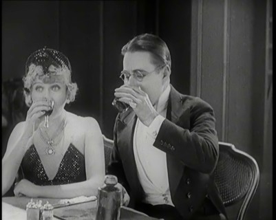 Scene from the Film 'A Little Bit of Fluff': The Female Actor Betty Balfour Sitting at a ..., 1920s. Creator: British Pathe Ltd.