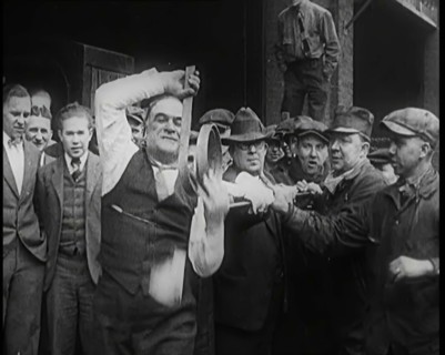 A Male Stuntman Bending Iron Bars Around His Head, 1926. Creator: British Pathe Ltd.