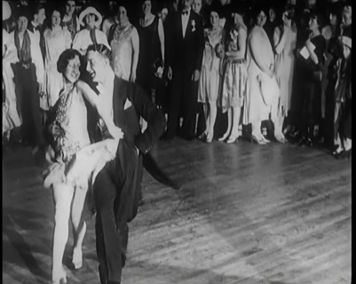 Female Civilian and Male Civilian Dancing in Front of a Crowd of People, 1926. Creator: British Pathe Ltd.