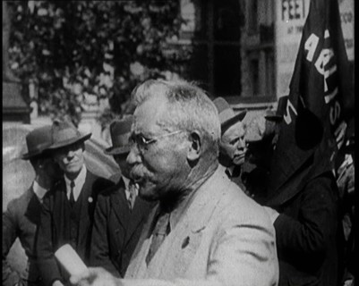 Male Civilian With Small Round Glasses and a Moustache Speaking.  Behind Are Male Civilians..., 1924 Creator: British Pathe Ltd.