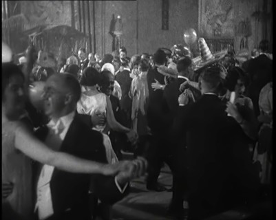 A Crowd of People Dancing at a Fancy Dress Party Whilst a Band is Playing on the Stage, 1920s. Creator: British Pathe Ltd.