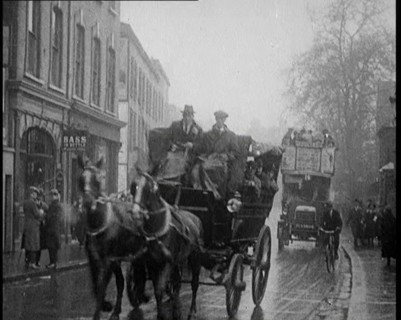 Vehicles Passing Along a Busy British Street, 1921. Creator: British Pathe Ltd.
