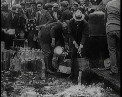 Prohibition Scenes in the United States of America. Men Smashing Bottles of Alcoholic..., 1920. Creator: British Pathe Ltd.