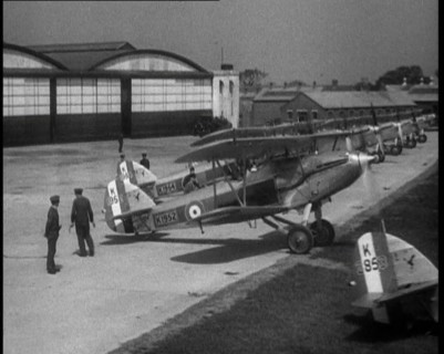 RAF Biplanes Taxiing Across a Field at tended to by Their Aircrews, 1933. Creator: British Pathe Ltd.