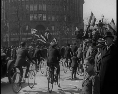 Male Civilians Driven in Trucks Parade Waving Flags. Other Male Civilians Ride Alongside on..., 1924 Creator: British Pathe Ltd.